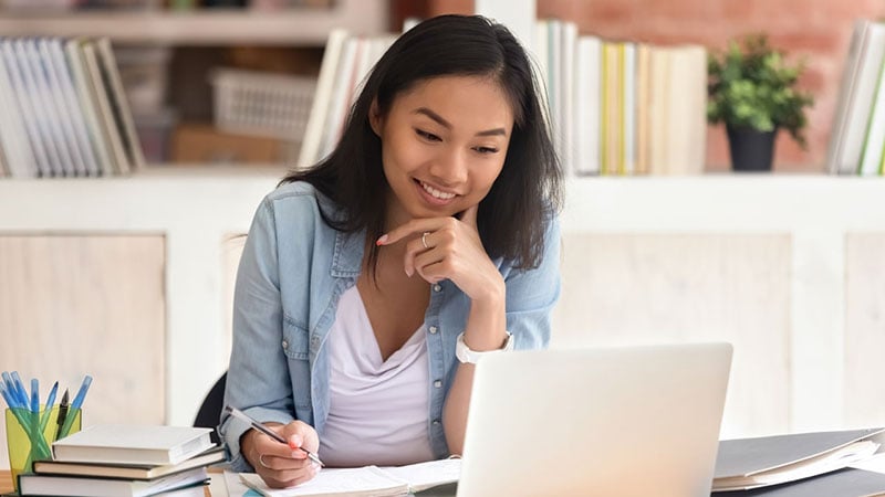 young woman sitting at desk stuying 