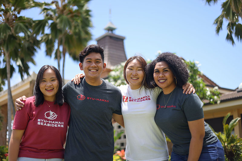 students standing together out front of BYU-Hawaii campus