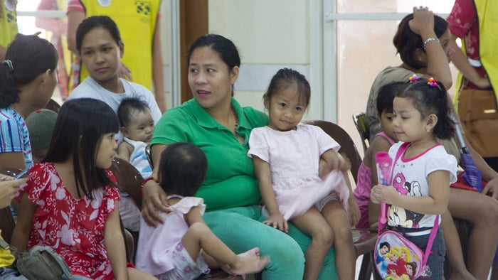 Families waiting for vaccinations in the Philippines