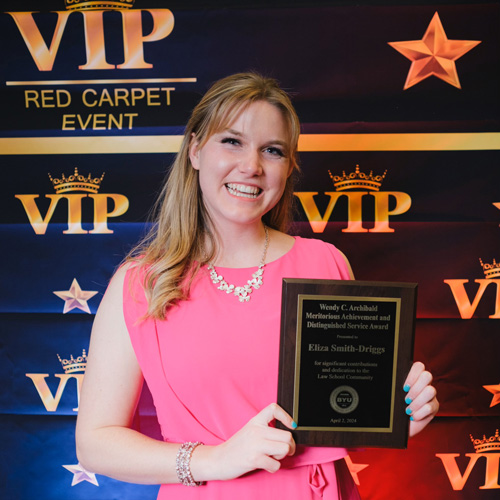 Eliza Driggs with an award at a VIP red carpet event