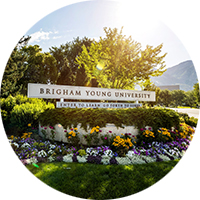 Sign reading "Brigham Young University" on BYU campus in spring