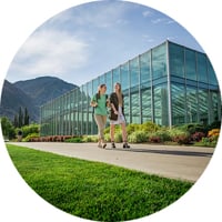 Two female BYU students walking on campus on a bright and sunny day