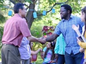 Two men shaking hands outdoors - LDS Philanthropies