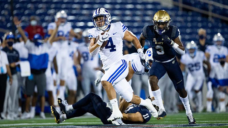 Lopini Katoa being chased by a Navy football player.