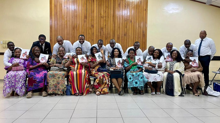 Participants in the Strengthening Marriage course in the Lagos Nigeria Ikeja Stake pose with their books.