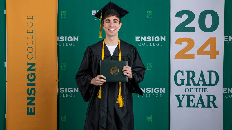 Caio Moyano de Almeida in his cap and gown with his Ensign College diploma