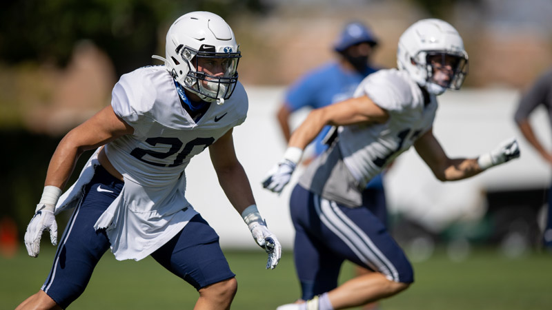 Photo of Hayden Livingston dropping into coverage during practice as a safety for BYU football.