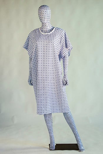 This BYU grad Madyson Ysasaga art features a mannequin of blue patterned fabric wearing a hospital gown of the same fabric.