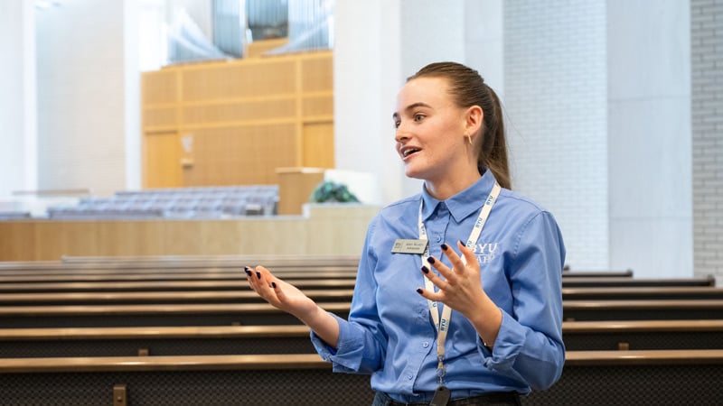 A female BYU-Idaho student inside a chapel giving a tour