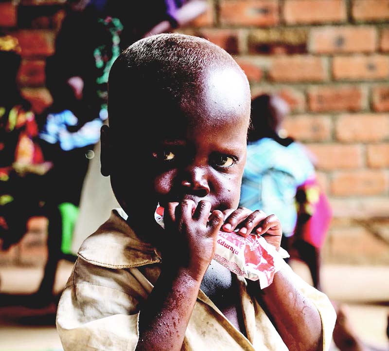 child in Central African Republic eating a therapeutic food paste