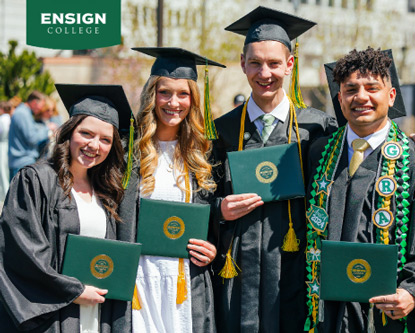 Four Ensign College graduates in the caps and gowns holding their diplomas