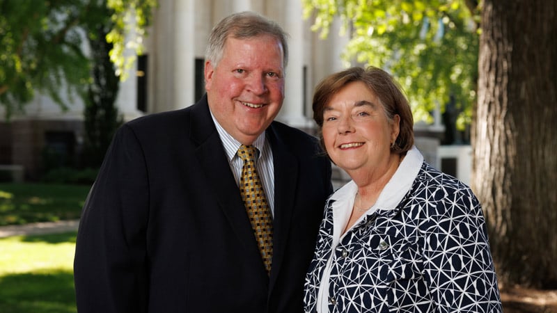 Man and woman in front of a campus building.