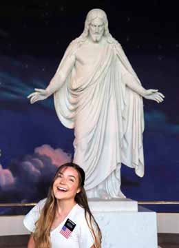 woman standing in front of the Christus statue in the Salt Lake City visitors center