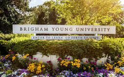 BYU sign saying “Enter to Learn Go Forth to Serve” surrounded by flowers.