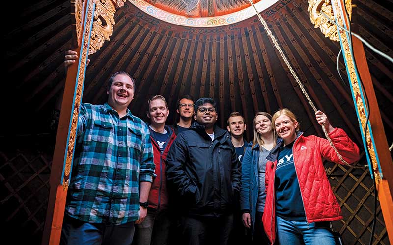 Seven BYU Engineering students in a Mongolian ger or tent house.