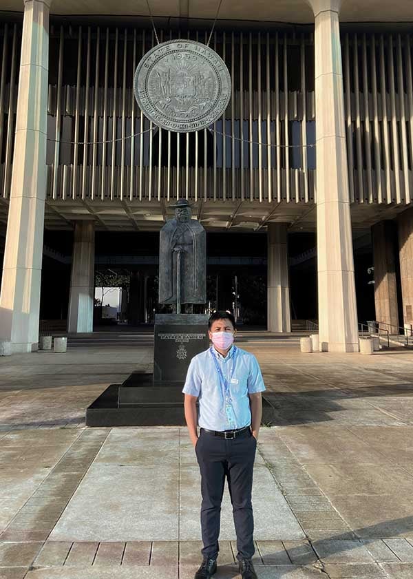 Filipino man standing in front of the Hawaii State Legislature