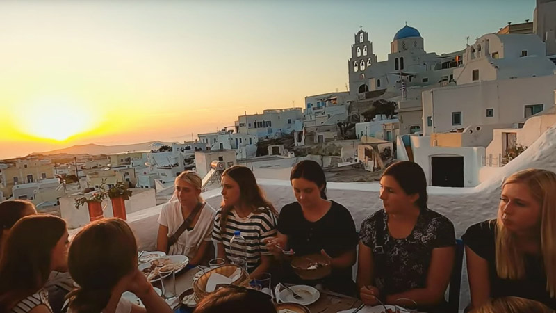 BYU students eating a meal in Greece