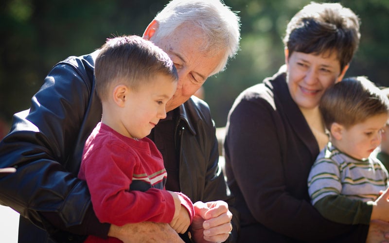 Man with grandson at a park.