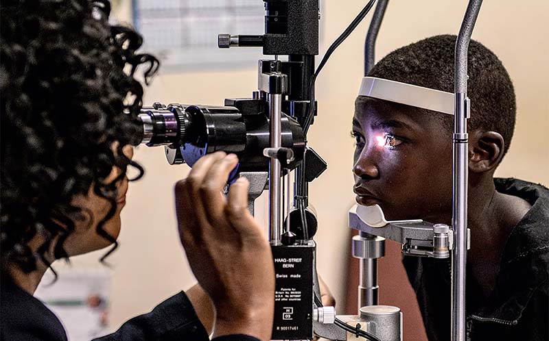 girl getting eye exam from a doctor
