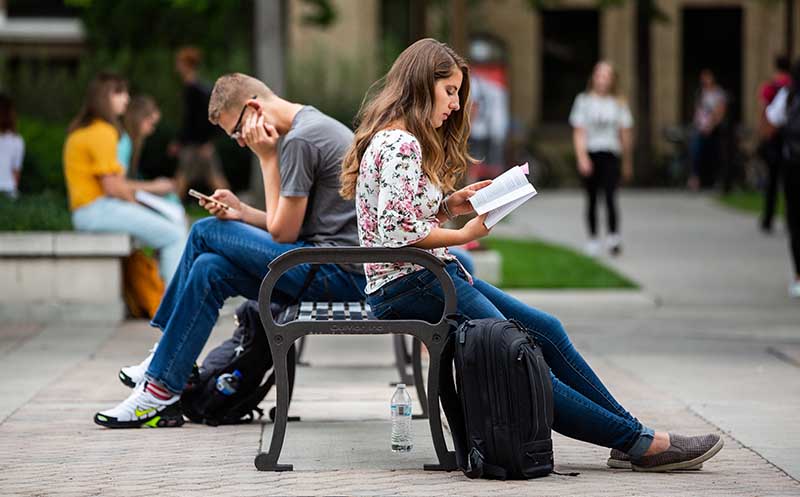 students at BYU sitting on a bench