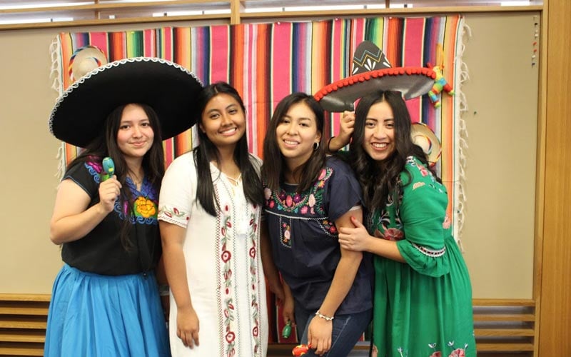 Four female Mexican Ensign College students pose for a photo at the Mexico Connect event