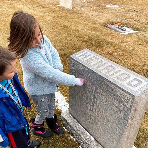 Whitney Peterson's kids looking at a grave