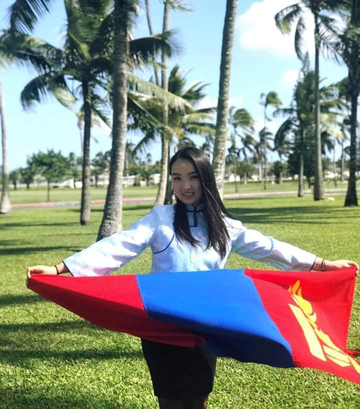 A young Mongolian woman holding the Mongolian flag.