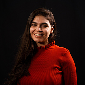 Portrait of a smiling BYU student wearing a red sweater.