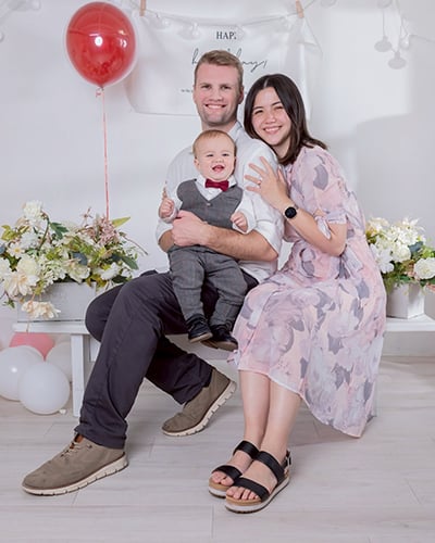 family sitting together on a bench