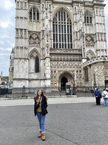 Female college student in front of Westminster Abbey