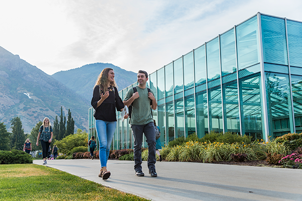 man and woman walking on BYU campus